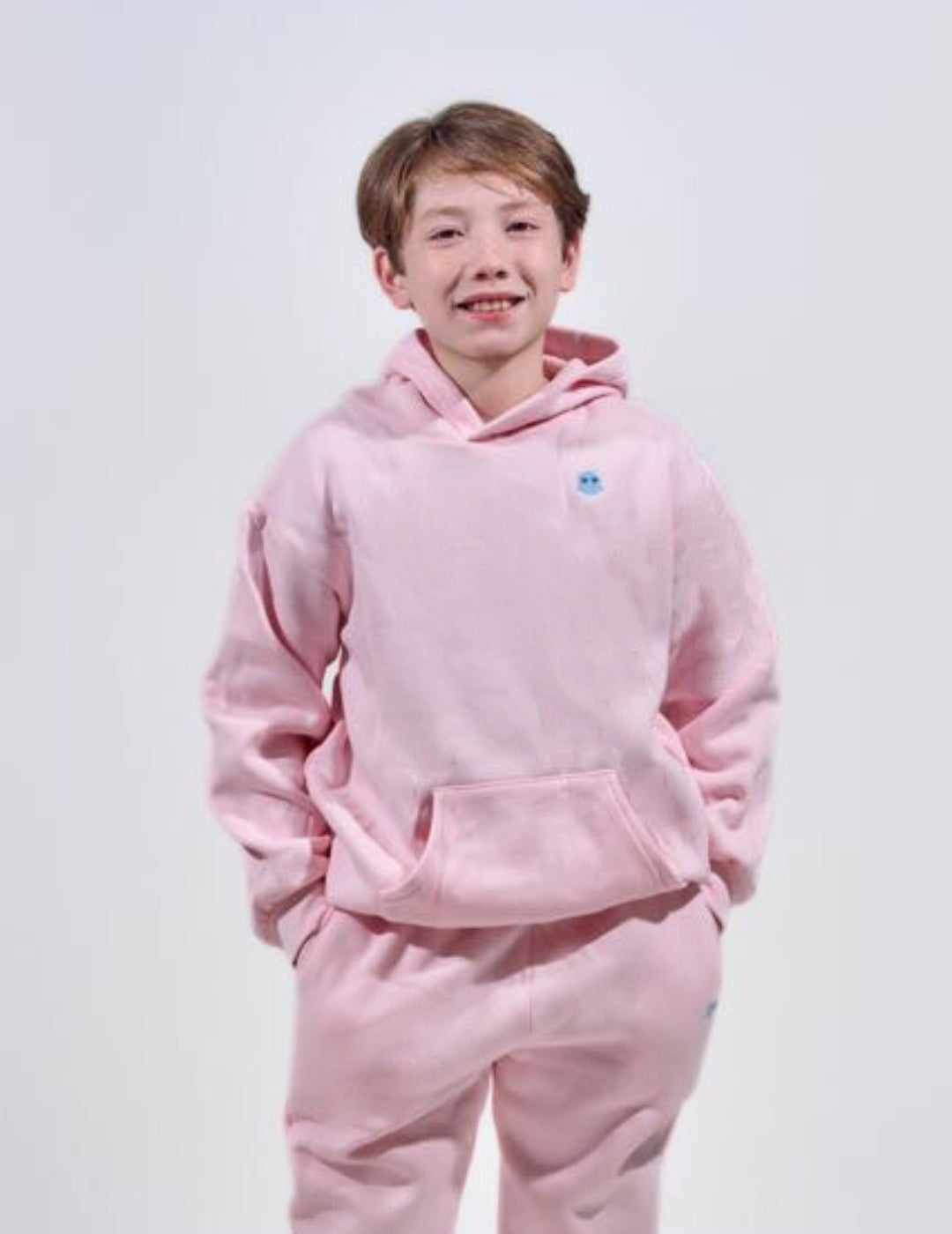 The Classic Kids Squiddy Hoodie in Baby Pink with boy model- Weighted Kids Hoodie with built-in squishies in the cuffs 2