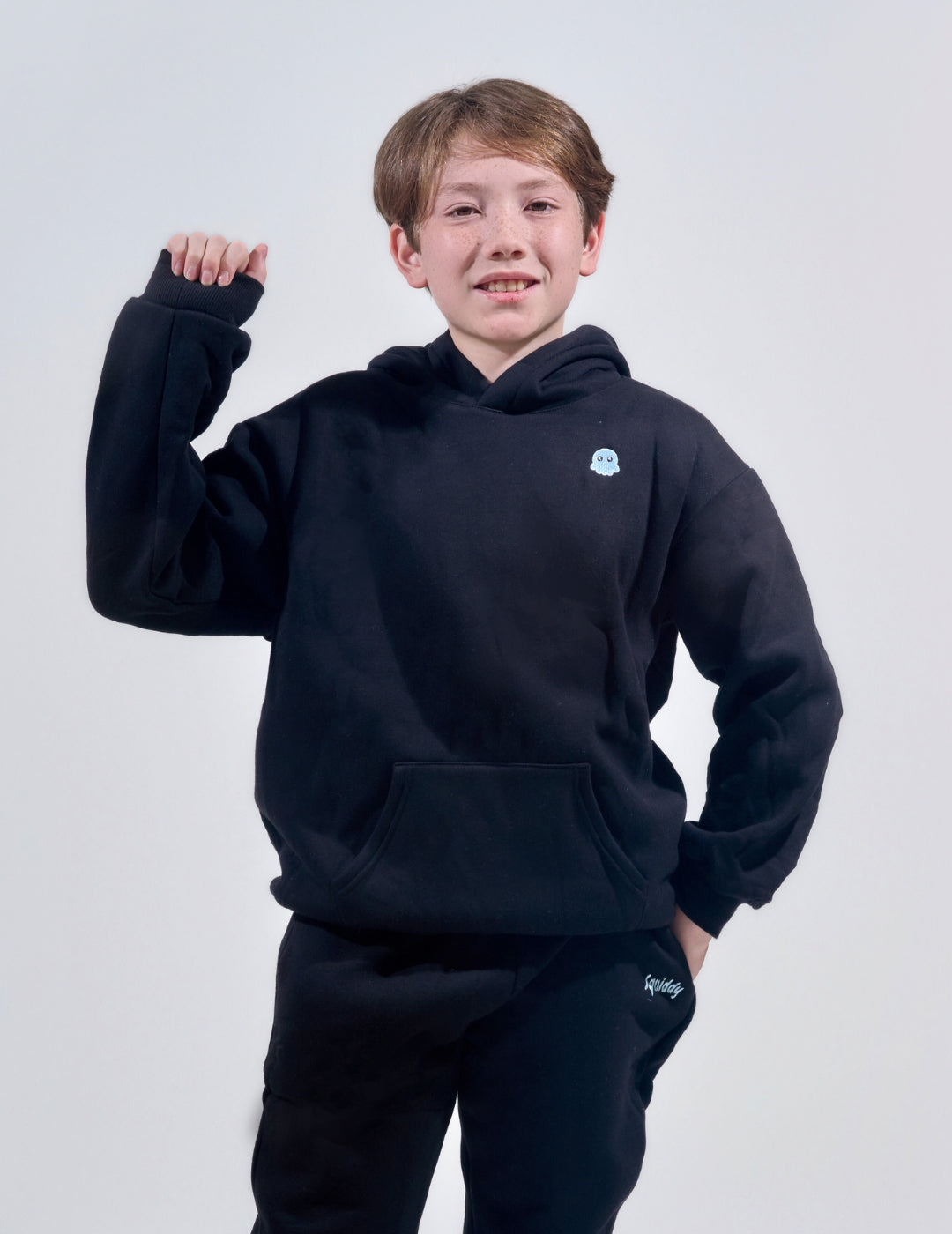 The Classic Kids Squiddy Hoodie in Black with boy model- Weighted Kids Hoodie with built-in squishies in the cuffs