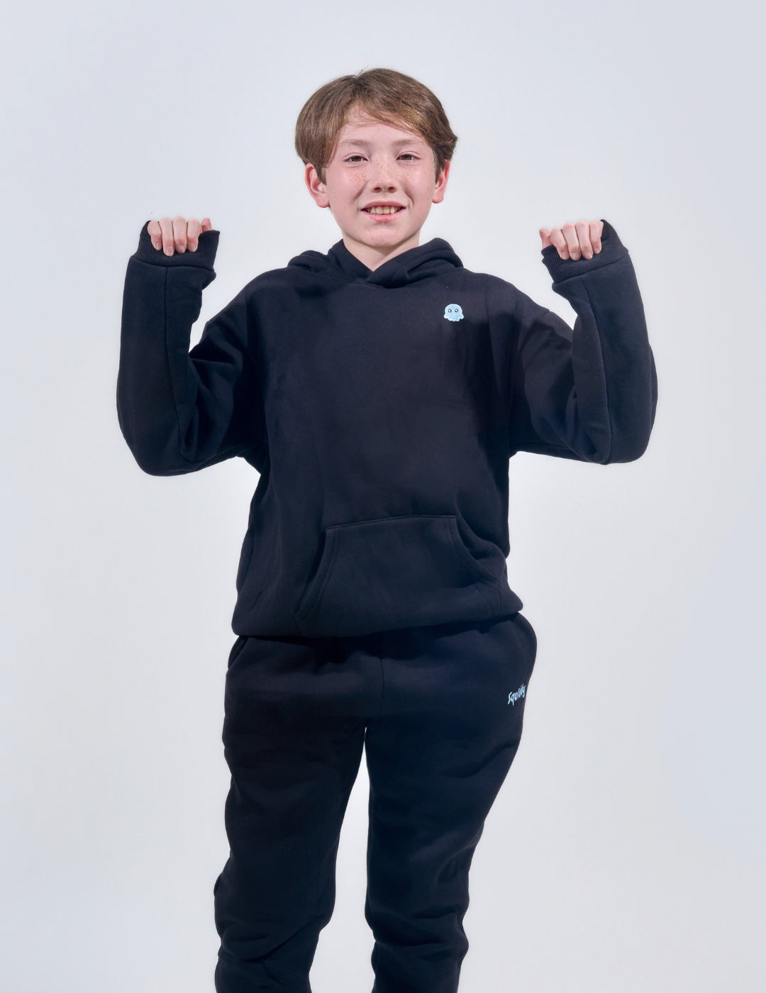 The Classic Kids Squiddy Hoodie in Black with boy model- Weighted Kids Hoodie with built-in squishies in the cuffs 2
