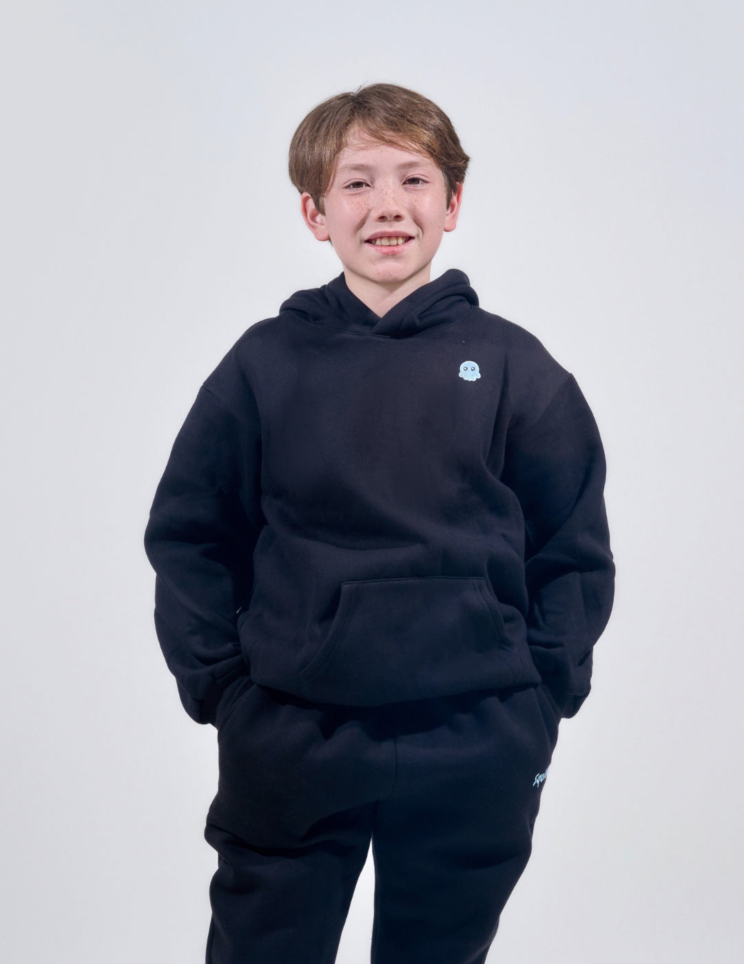 The Classic Kids Squiddy Hoodie in Black with boy model- Weighted Kids Hoodie with built-in squishies in the cuffs 3