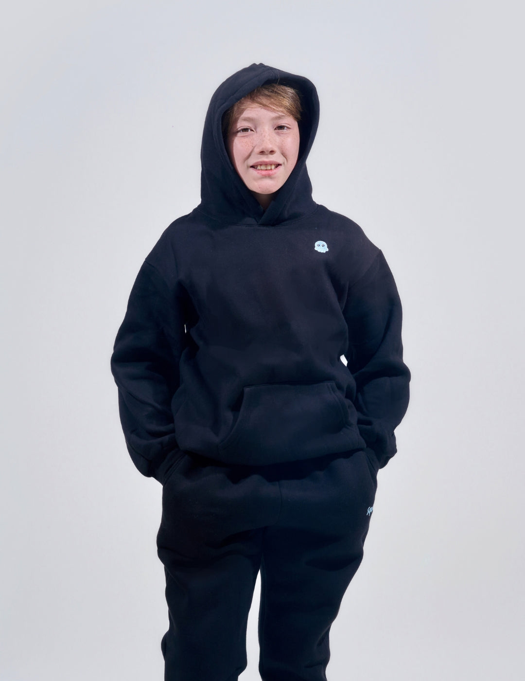 The Classic Kids Squiddy Hoodie in Black with boy model- Weighted Kids Hoodie with built-in squishies in the cuffs 4