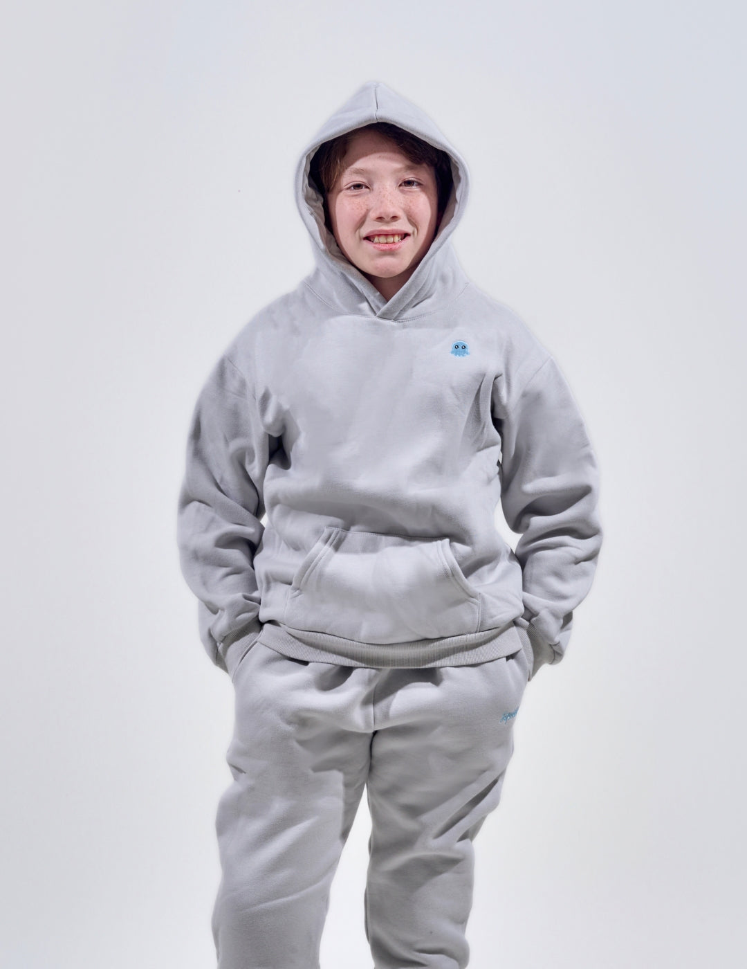 The Classic Kids Squiddy Hoodie in Fog Grey with boy model- Weighted Kids Hoodie with built-in squishies in the cuffs 4