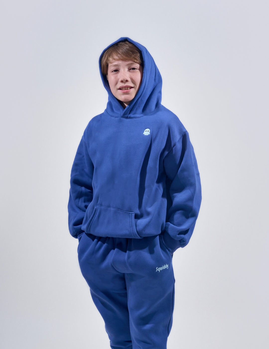 The Classic Kids Squiddy Hoodie in NavyBlue with boy model- Weighted Kids Hoodie with built-in squishies in the cuffs 4