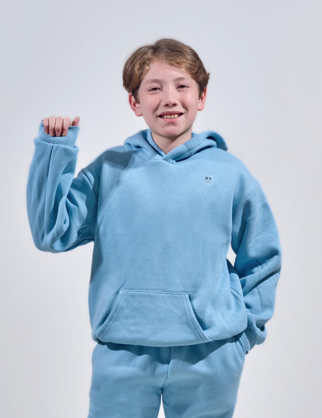 The Classic Kids Squiddy Hoodie in Sky Blue with boy model- Weighted Kids Hoodie with built-in squishies in the cuffs