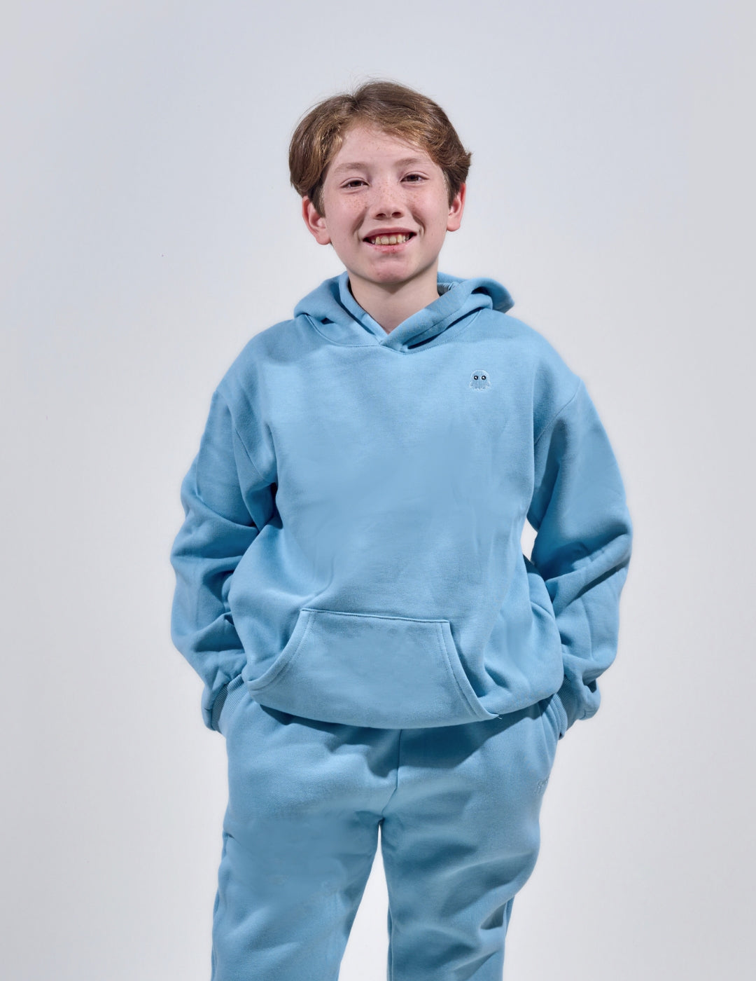 The Classic Kids Squiddy Hoodie in Sky Blue with boy model- Weighted Kids Hoodie with built-in squishies in the cuffs 2