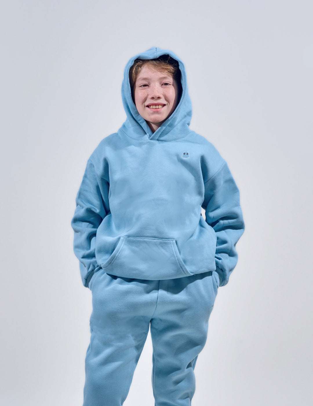 The Classic Kids Squiddy Hoodie in Sky Blue with boy model- Weighted Kids Hoodie with built-in squishies in the cuffs 4