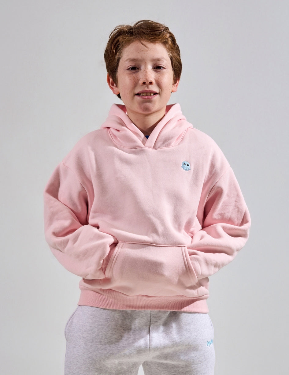 The Classic Kids Squiddy Hoodie in Baby Pink with boy model- Weighted Kids Hoodie with built-in squishies in the cuffs
