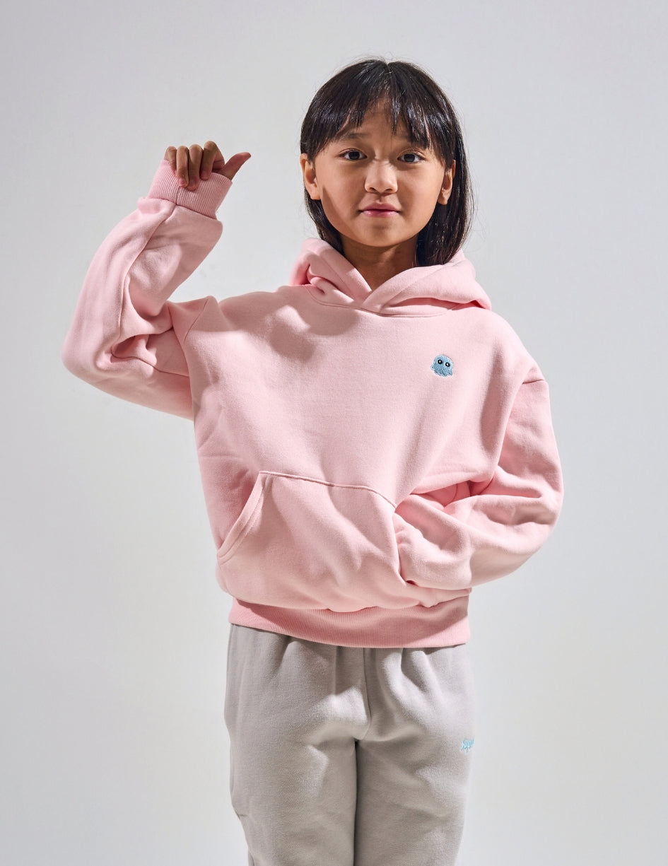 The Classic Kids Squiddy Hoodie in Baby Pink with girl model- Weighted Kids Hoodie with built-in squishies in the cuffs