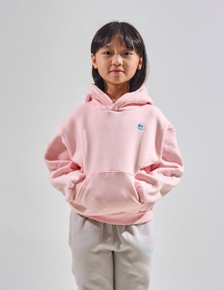 The Classic Kids Squiddy Hoodie in Baby Pink with girl model- Weighted Kids Hoodie with built-in squishies in the cuffs
