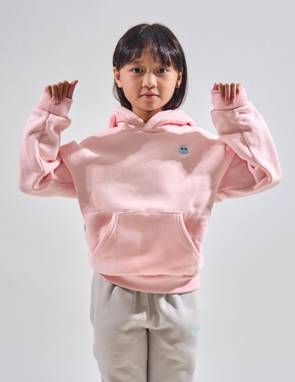 The Classic Kids Squiddy Hoodie in Baby Pink with girl model- Weighted Kids Hoodie with built-in squishies in the cuffs