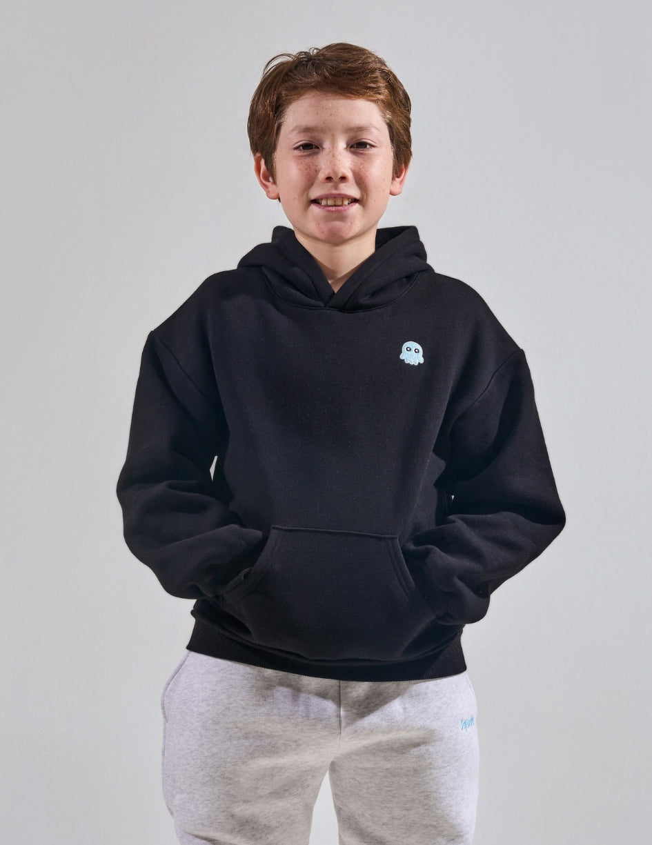 The Classic Kids Squiddy Hoodie in Black with boy model- Weighted Kids Hoodie with built-in squishies in the cuffs