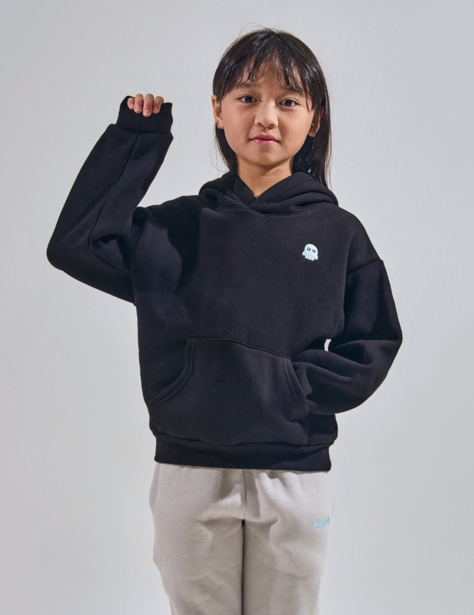 The Classic Kids Squiddy Hoodie in Black with girl model- Weighted Kids Hoodie with built-in squishies in the cuffs