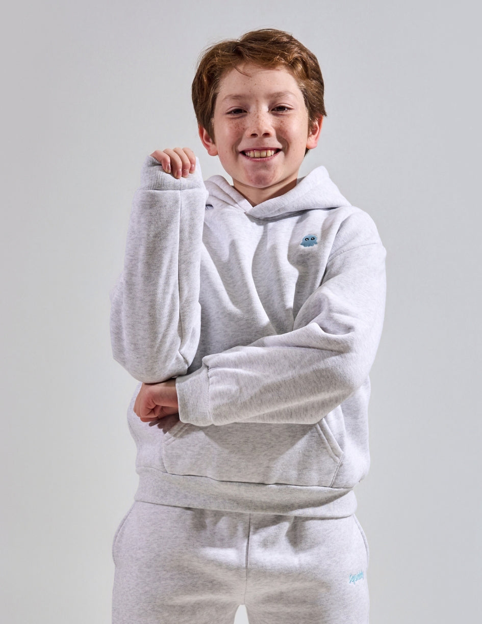 The Classic Kids Squiddy Hoodie in Light Grey with boy model- Weighted Kids Hoodie with built-in squishies in the cuffs