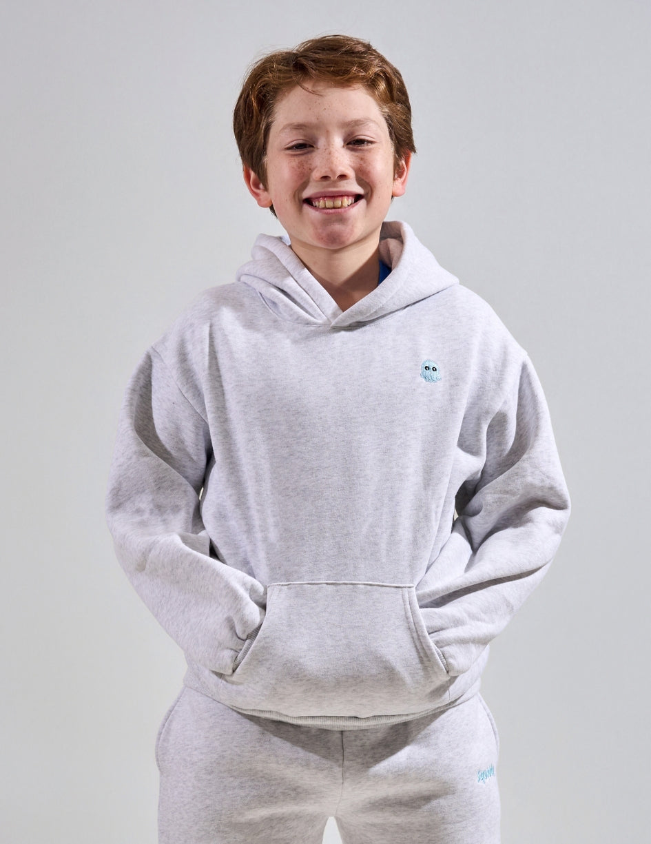 The Classic Kids Squiddy Hoodie in Light Grey with boy model- Weighted Kids Hoodie with built-in squishies in the cuffs