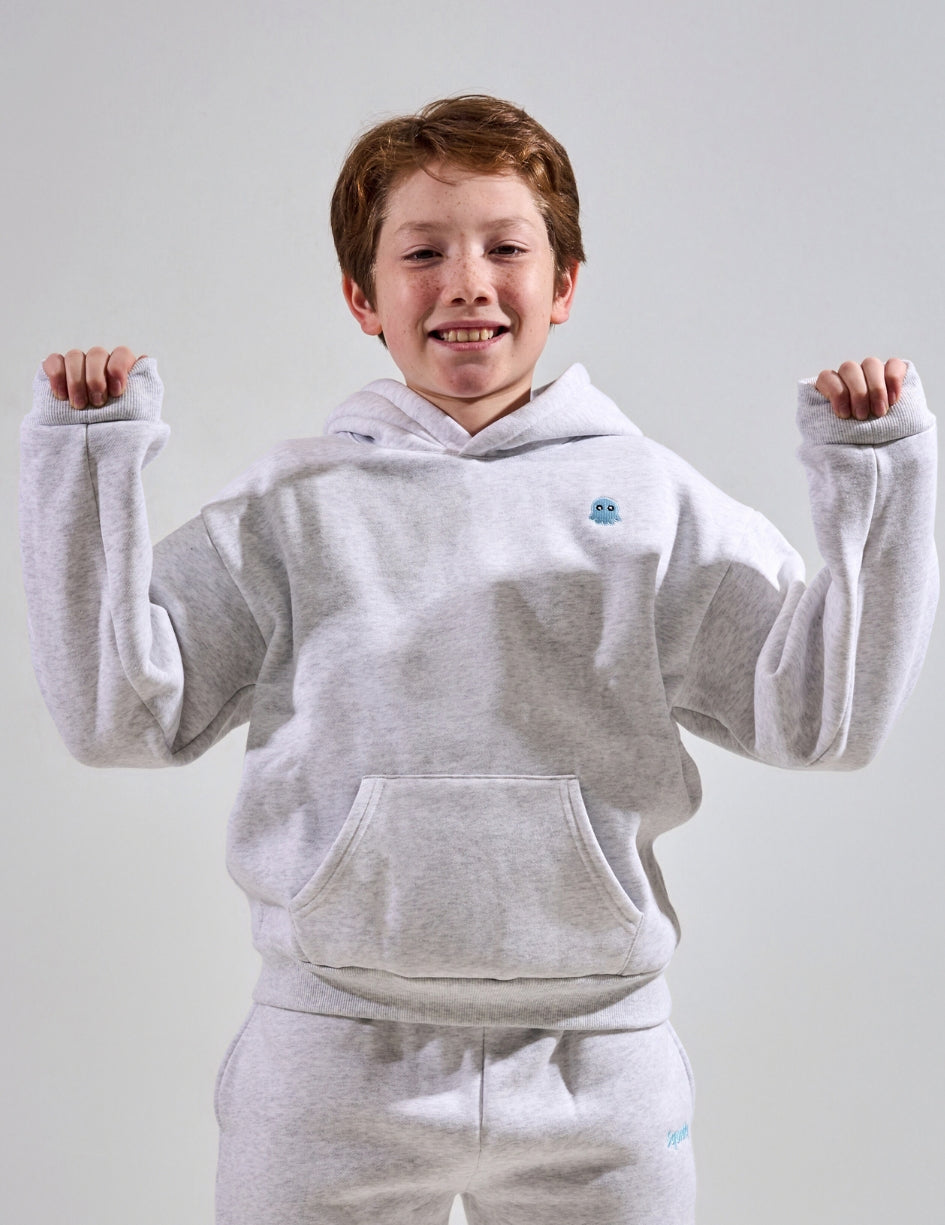 The Classic Kids Squiddy Hoodie in Light Grey with boy model- Weighted Kids Hoodie with built-in squishies in the cuffs