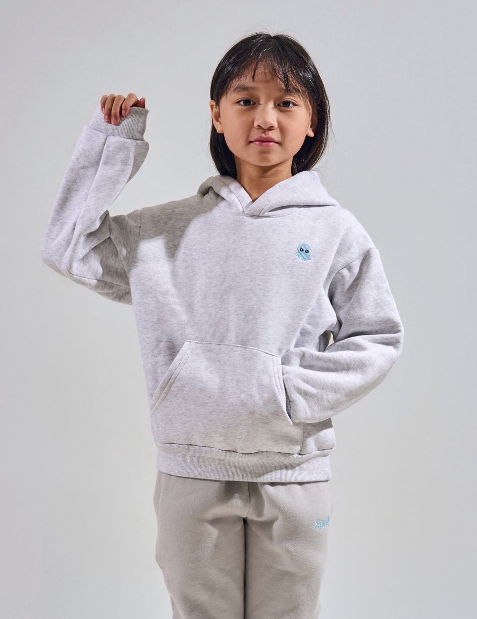 The Classic Kids Squiddy Hoodie in Light Grey with girl model- Weighted Kids Hoodie with built-in squishies in the cuffs