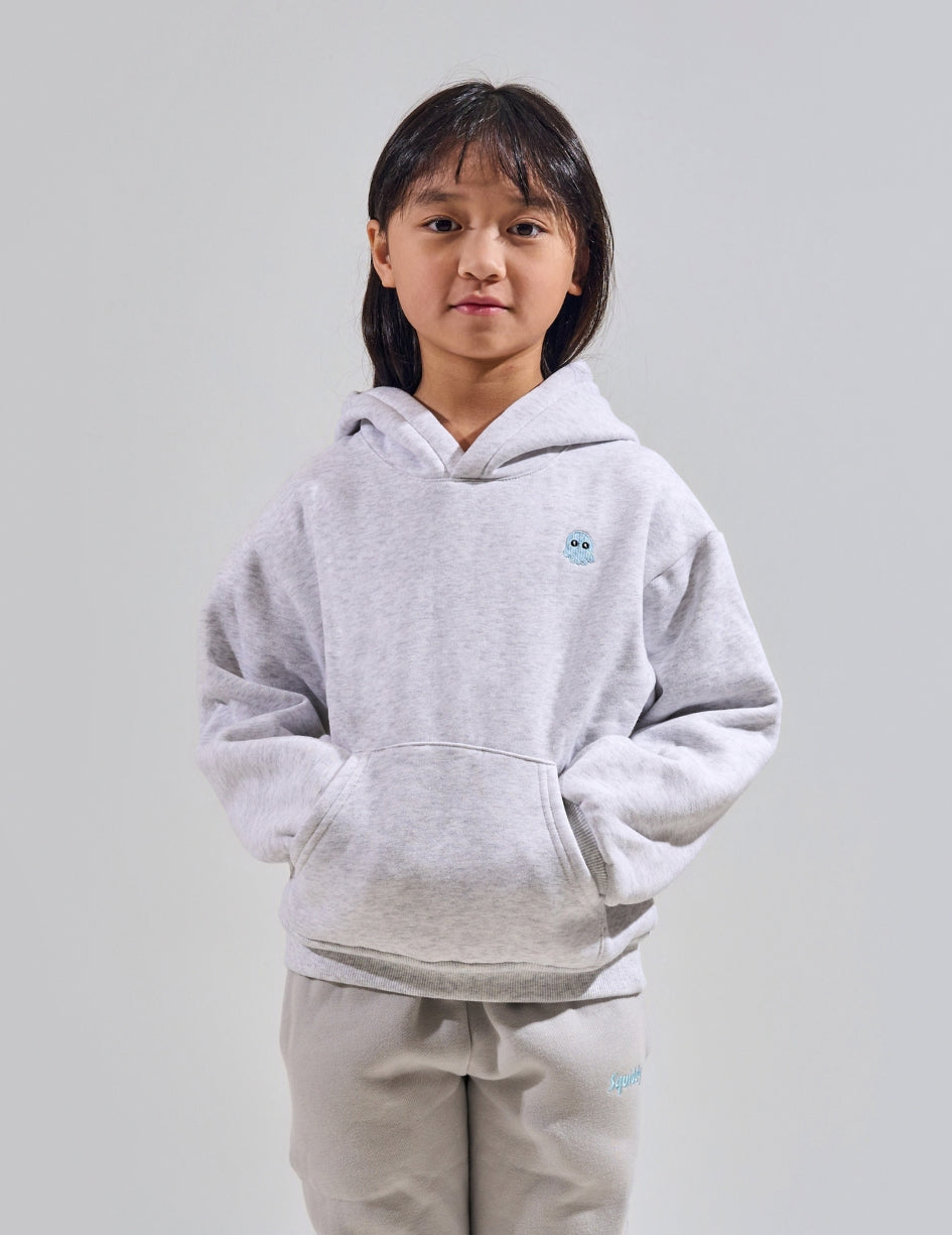 The Classic Kids Squiddy Hoodie in Light Grey with girl model- Weighted Kids Hoodie with built-in squishies in the cuffs