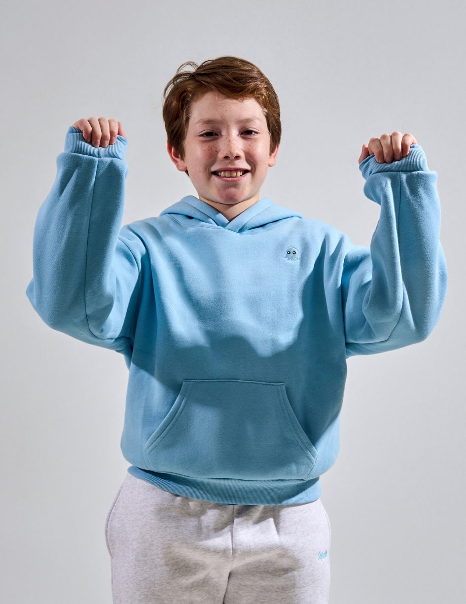 The Classic Kids Squiddy Hoodie in Sky Blue with boy model- Weighted Kids Hoodie with built-in squishies in the cuffs