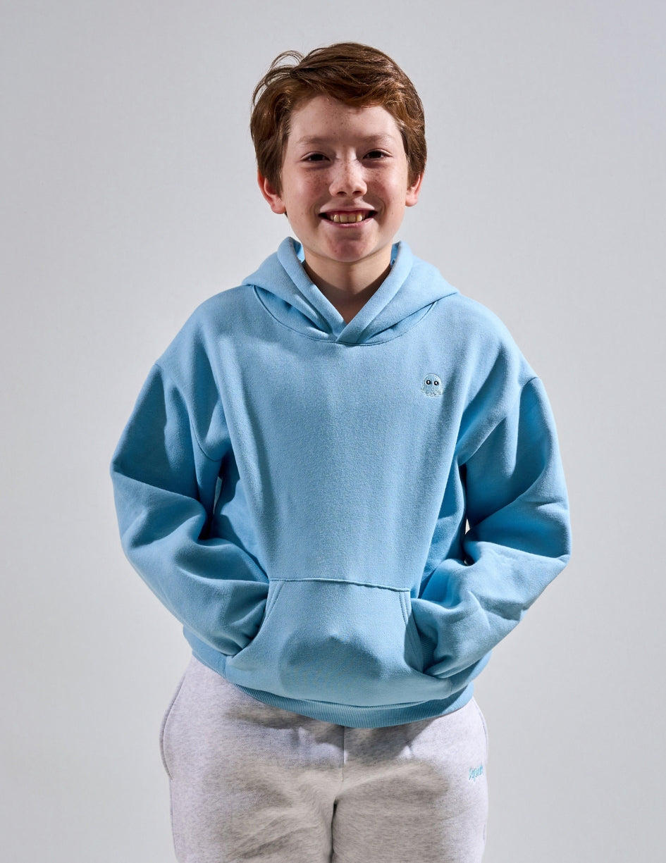 The Classic Kids Squiddy Hoodie in Sky Blue with boy model- Weighted Kids Hoodie with built-in squishies in the cuffs