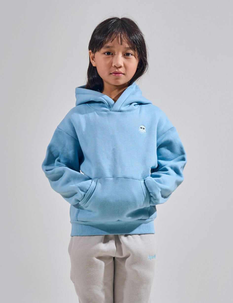 The Classic Kids Squiddy Hoodie in Sky Blue with girl model- Weighted Kids Hoodie with built-in squishies in the cuffs