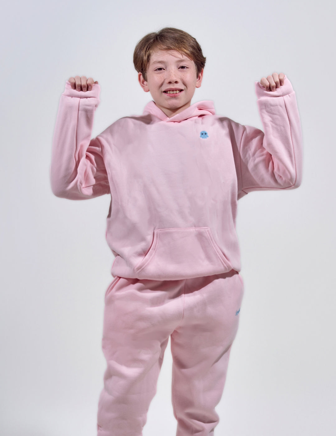 The Classic Kids Squiddy Hoodie in  Baby Pink with boy model- Weighted Kids Hoodie with built-in squishies in the cuffs 3