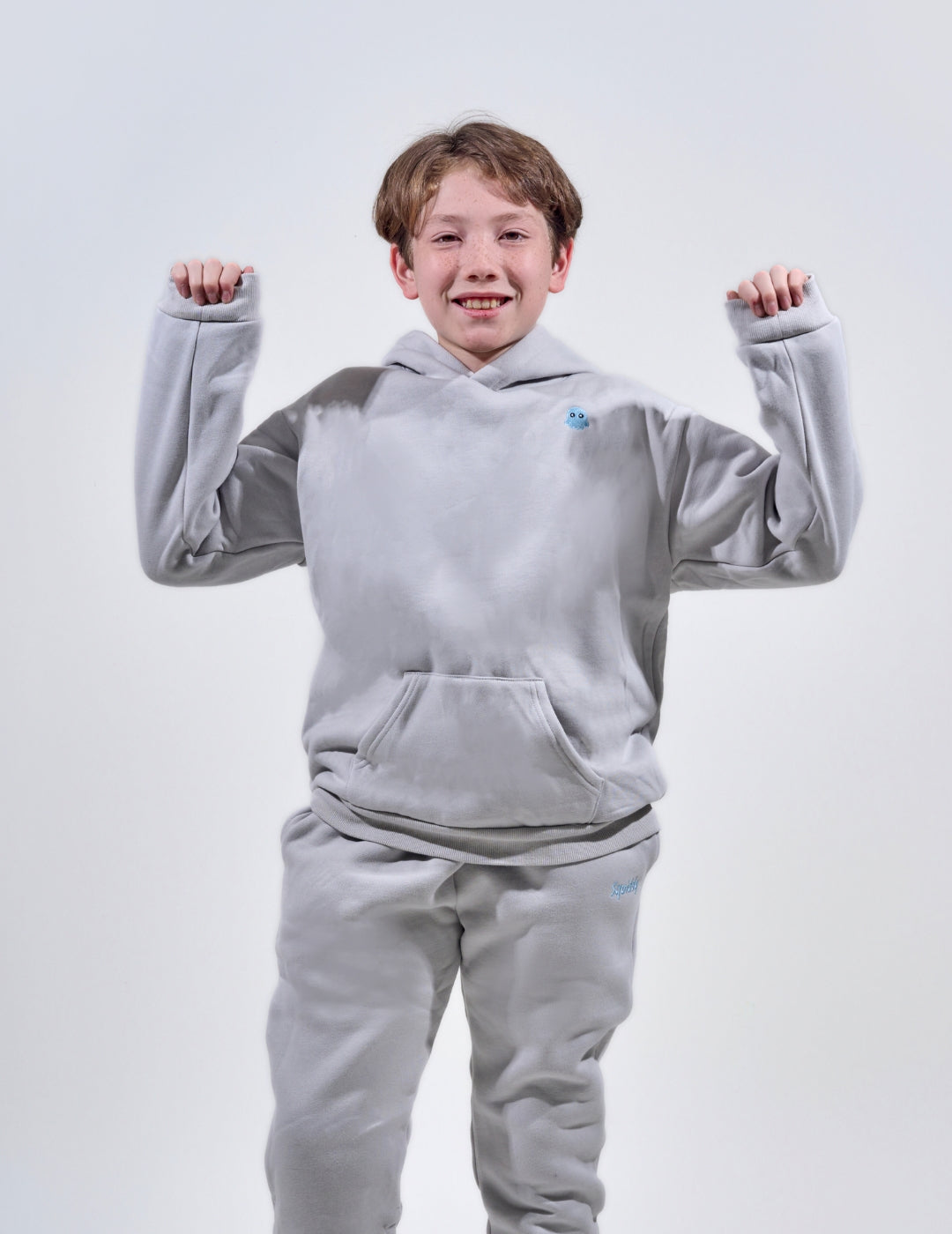 The Classic Kids Squiddy Hoodie in Fog Grey with boy model- Weighted Kids Hoodie with built-in squishies in the cuffs 2