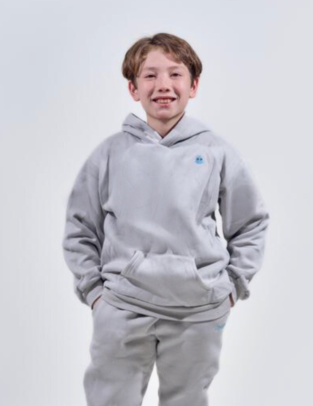 The Classic Kids Squiddy Hoodie in Fog Grey with boy model- Weighted Kids Hoodie with built-in squishies in the cuffs 3