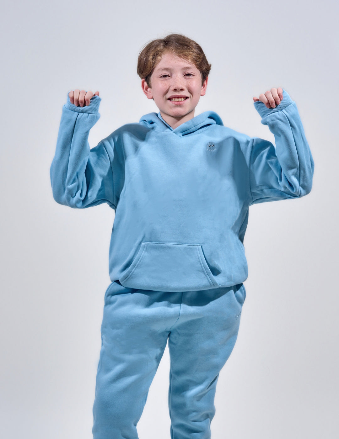 The Classic Kids Squiddy Hoodie in  Sky Blue with boy model- Weighted Kids Hoodie with built-in squishies in the cuffs 3