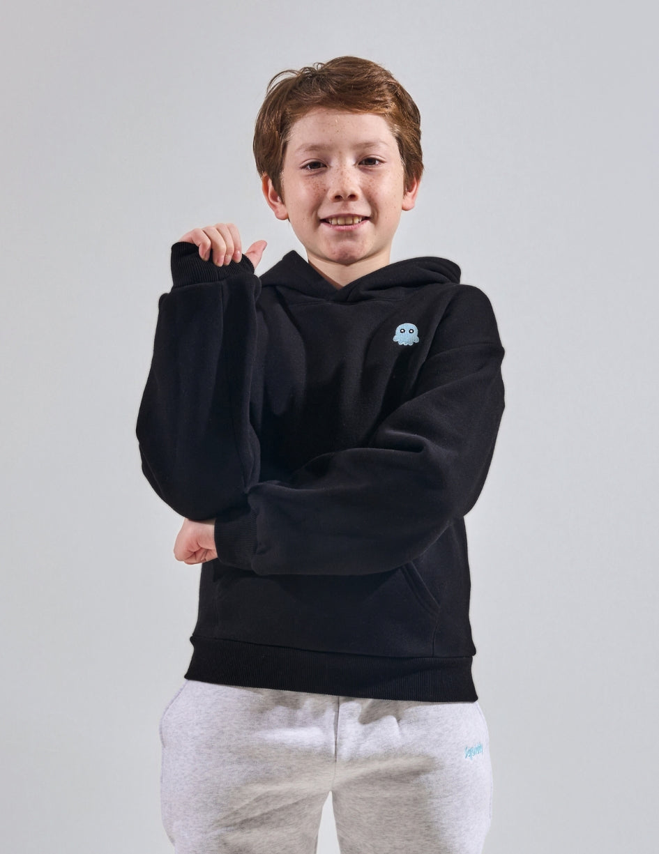 The Classic Kids Squiddy Hoodie in Black with boy model- Weighted Kids Hoodie with built-in squishies in the cuffs