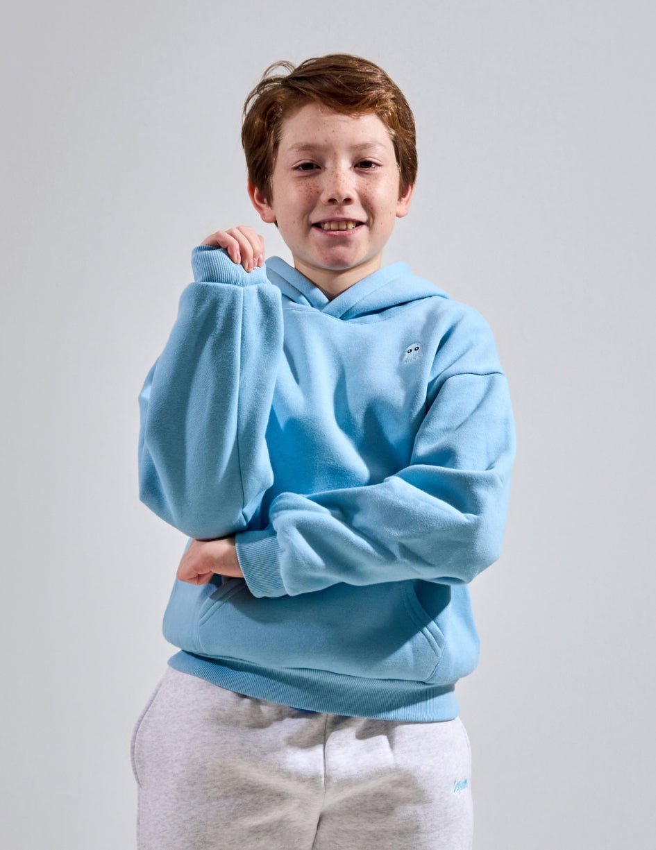 The Classic Kids Squiddy Hoodie in Sky Blue with boy model- Weighted Kids Hoodie with built-in squishies in the cuffs